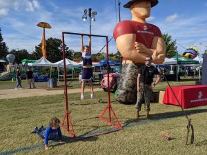 Children doing pull ups and push ups at Marine tent